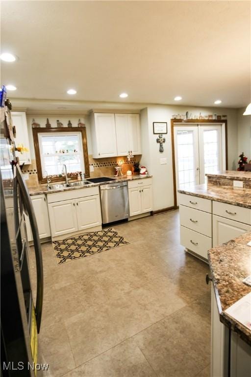 kitchen with white cabinetry, sink, and appliances with stainless steel finishes