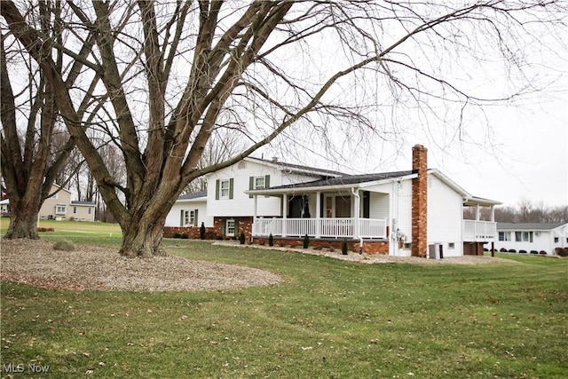 view of home's exterior featuring a porch and a yard