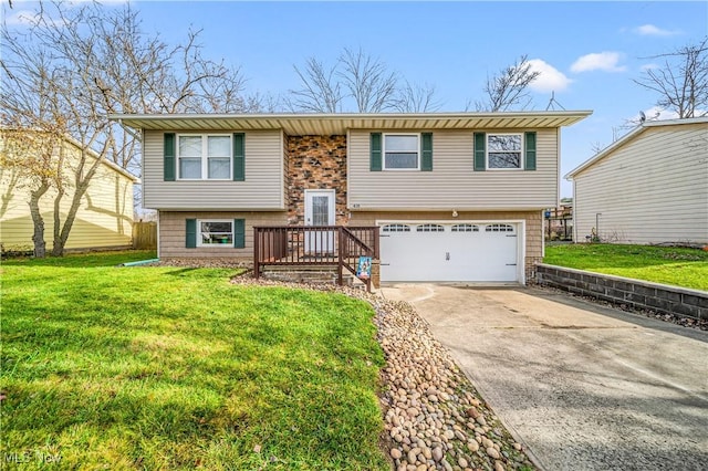 raised ranch featuring a front yard and a garage