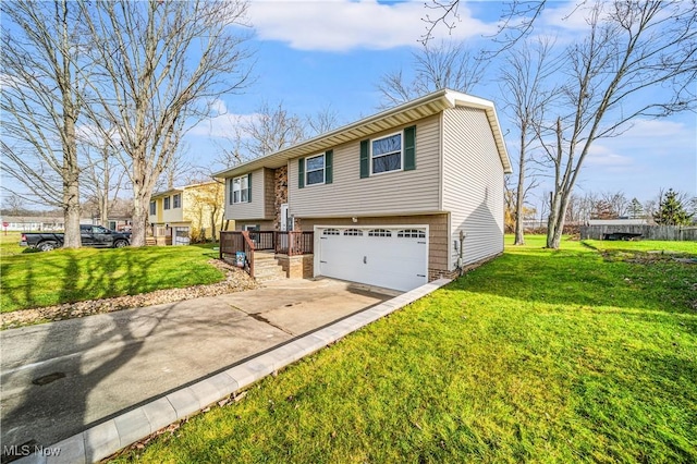 bi-level home featuring a garage and a front yard