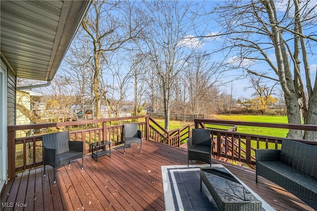 wooden terrace featuring a lawn