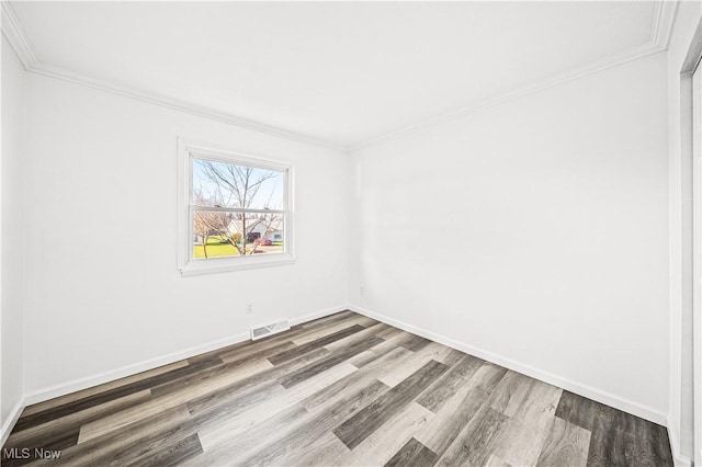 unfurnished room featuring wood-type flooring and crown molding