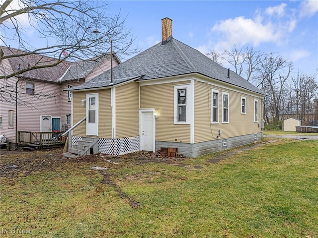 back of house featuring a yard