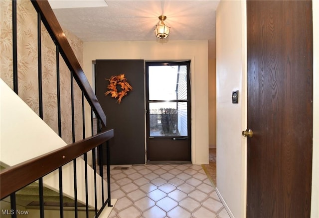 foyer with a textured ceiling