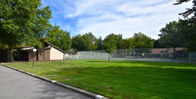 view of yard with tennis court