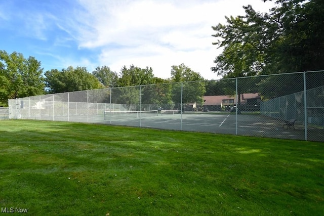 view of sport court featuring a lawn