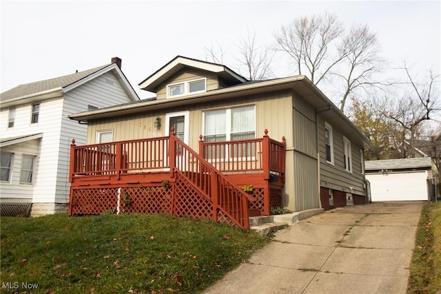 view of front of house with a garage, an outbuilding, and a front lawn