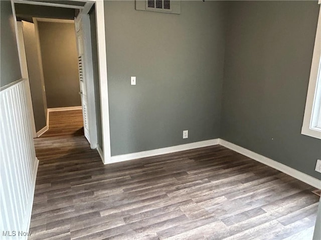 unfurnished room with dark hardwood / wood-style floors