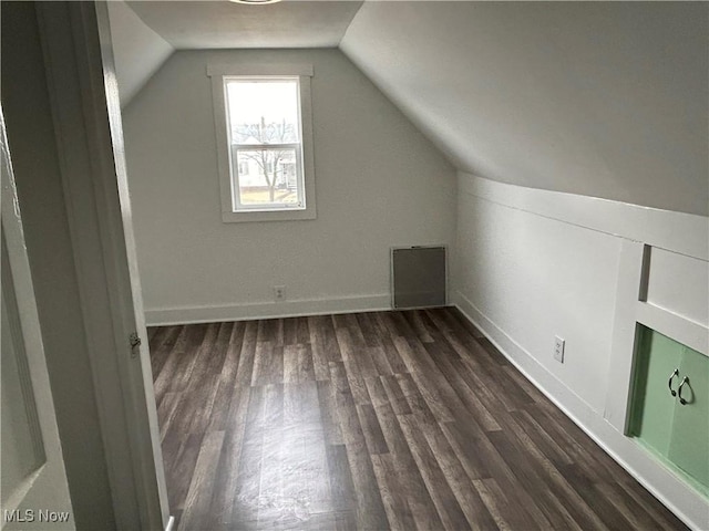 additional living space featuring dark hardwood / wood-style flooring and lofted ceiling