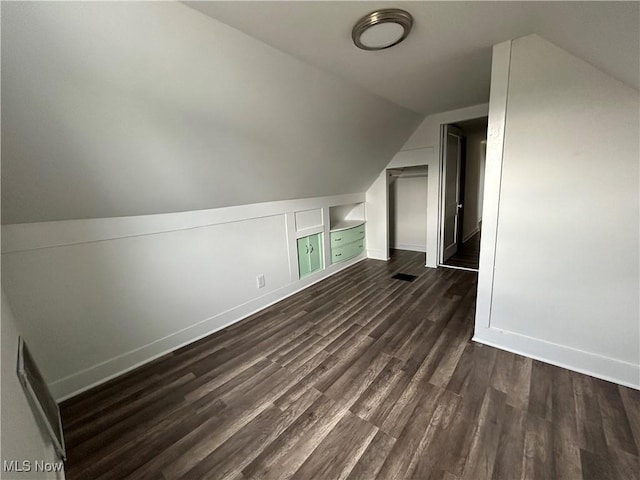 additional living space with lofted ceiling and dark hardwood / wood-style flooring