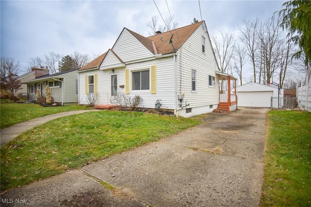 view of front of property with a front yard, a garage, and an outdoor structure