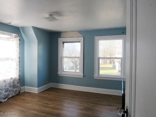 empty room with dark hardwood / wood-style floors