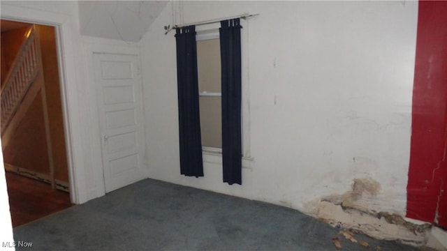 empty room featuring dark colored carpet