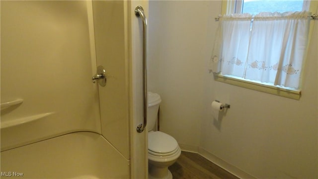 bathroom featuring hardwood / wood-style floors and toilet