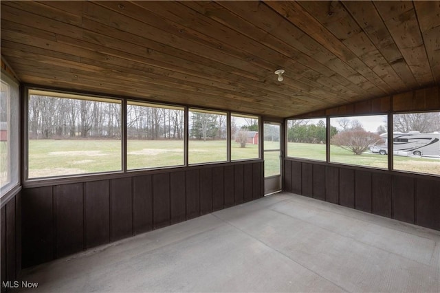 unfurnished sunroom with plenty of natural light, lofted ceiling, and wooden ceiling