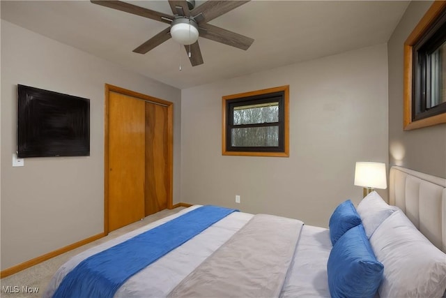 bedroom with ceiling fan, a closet, and carpet