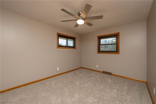 spare room with light carpet and ceiling fan