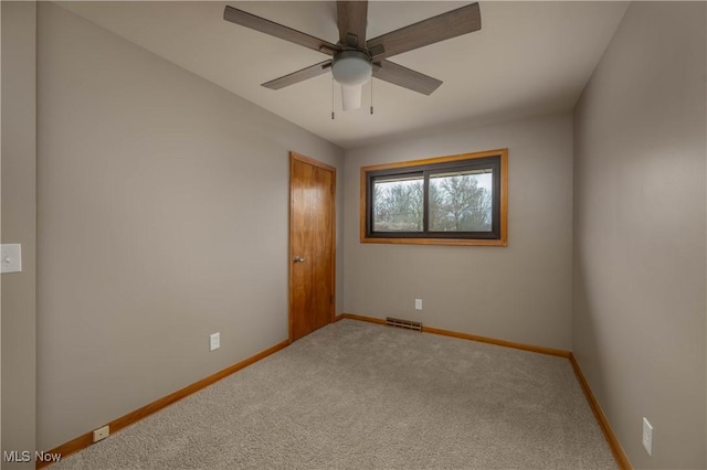 carpeted empty room with ceiling fan