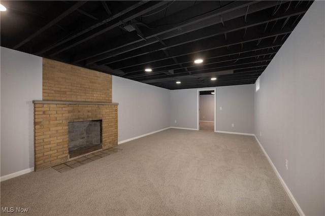 basement featuring a fireplace and light colored carpet