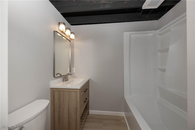 bathroom with vanity, hardwood / wood-style flooring, and toilet