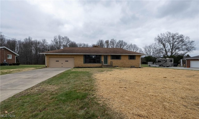 ranch-style house featuring a garage and a front lawn