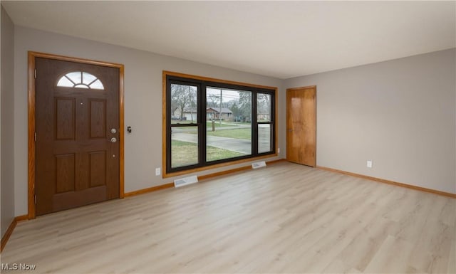 foyer entrance with plenty of natural light and light wood-type flooring