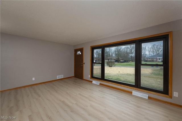 spare room featuring light hardwood / wood-style floors