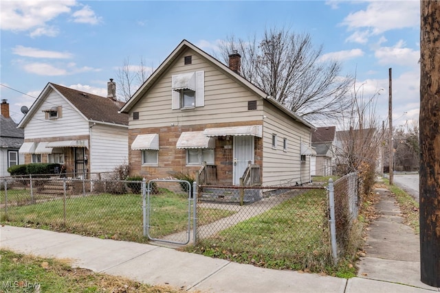 bungalow-style home featuring a front lawn