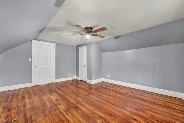 additional living space with a textured ceiling, ceiling fan, lofted ceiling, and hardwood / wood-style flooring