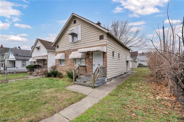 bungalow-style house with a front yard