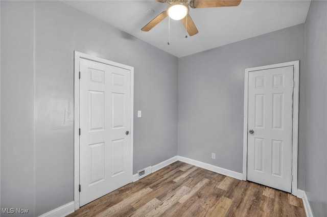 empty room featuring hardwood / wood-style floors and ceiling fan