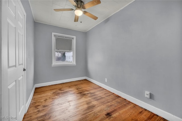 unfurnished room with ceiling fan, wood-type flooring, and crown molding