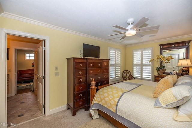 bedroom with light colored carpet, ceiling fan, and crown molding