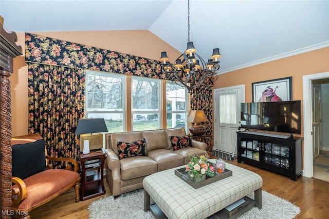 living room with a chandelier, ornamental molding, hardwood / wood-style flooring, and lofted ceiling