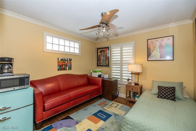 bedroom featuring dark hardwood / wood-style floors, ceiling fan, and crown molding