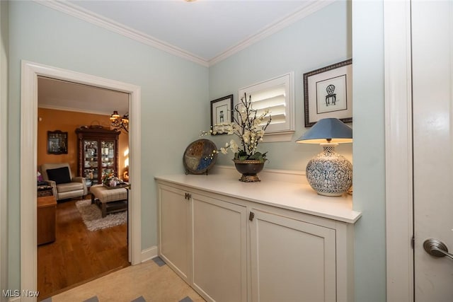 corridor featuring light hardwood / wood-style flooring and crown molding