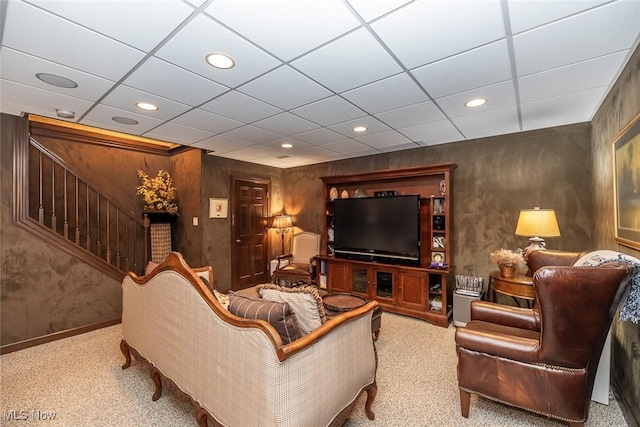 carpeted cinema with a paneled ceiling