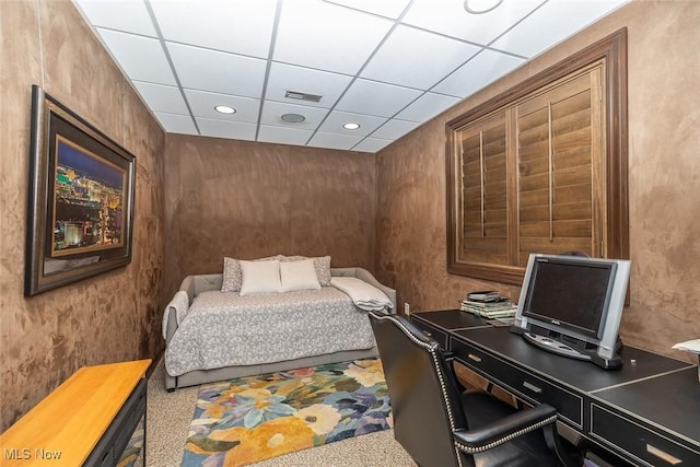 carpeted bedroom with a paneled ceiling