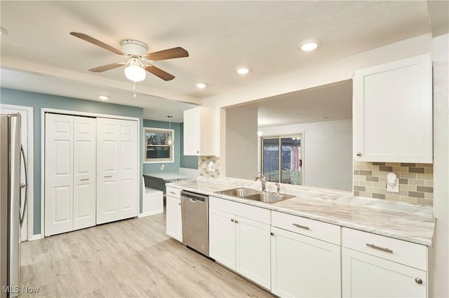 kitchen featuring white cabinetry, stainless steel appliances, and light hardwood / wood-style flooring