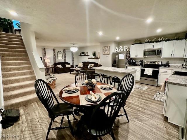 dining area with light hardwood / wood-style floors and sink