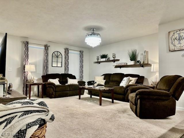 carpeted living room featuring a textured ceiling