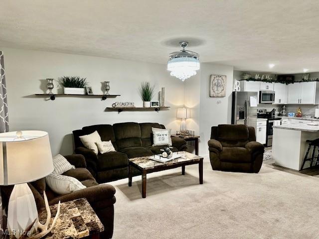 carpeted living room featuring a textured ceiling