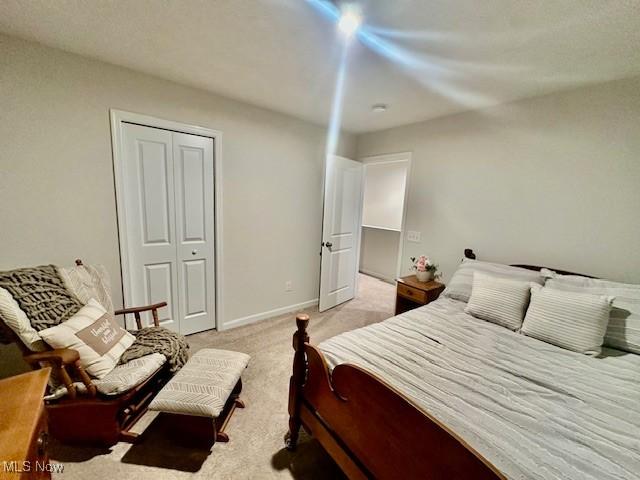 carpeted bedroom featuring a closet