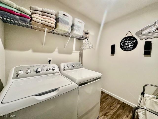 washroom featuring dark wood-type flooring and independent washer and dryer