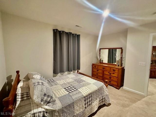 bedroom featuring light colored carpet