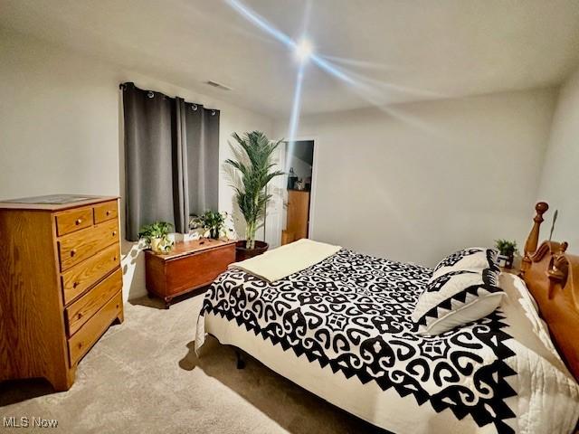 bedroom with light carpet