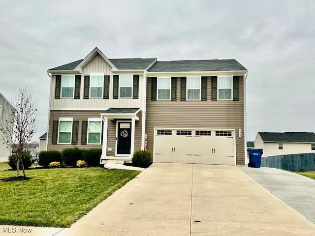 view of front of house featuring a front yard and a garage