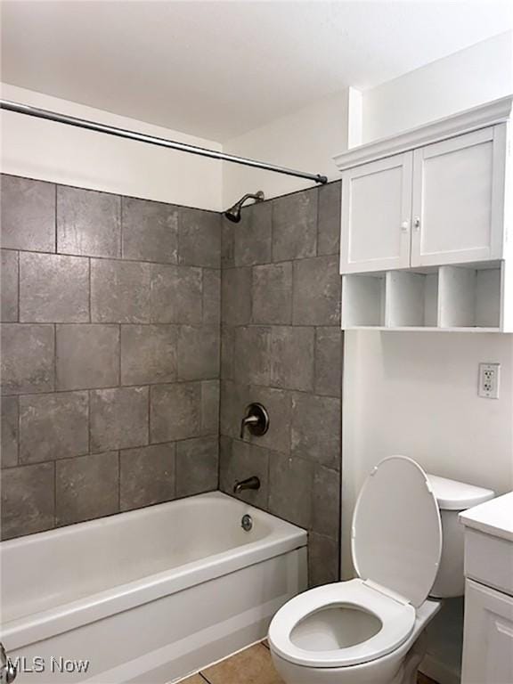 full bathroom featuring tile patterned floors, vanity, toilet, and tiled shower / bath