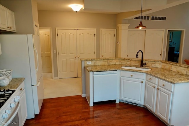 kitchen with dark hardwood / wood-style flooring, white appliances, sink, white cabinets, and hanging light fixtures