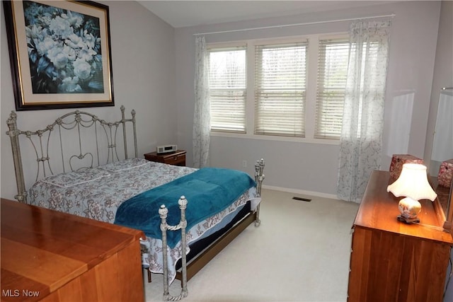 carpeted bedroom featuring multiple windows